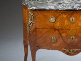 a marble top chest of drawers on a stand