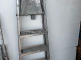 two ladders that are leaning against a wall in a room