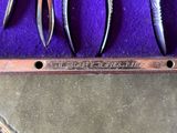 three pairs of pliers are in a purple case on a table