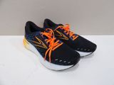 a pair of black and orange running shoes with orange laces