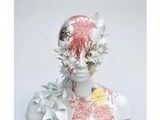 a sculpture of a woman with flowers on her head