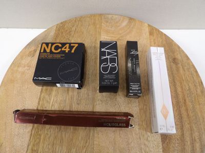 a wooden table with a pen, pencil, and a box on it