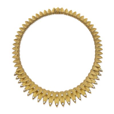a gold necklace on a white background