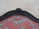 a red couch with a floral pattern on it