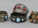 three silver bracelets and a ring with turquoise, coral and coral stones