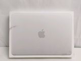 a white apple laptop sitting on top of a table
