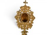 an image of a gold colored clock with a cross on it