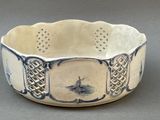 a white bowl with a blue and white design on it
