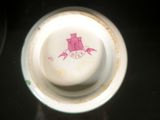 a white cup with a pink design on it