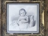 an old picture of a little girl in a dress sitting in a chair