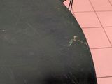 a black table with a black top and a black chair