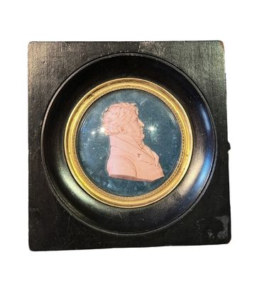 an image of a miniature picture of a woman in a black frame