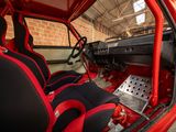 the interior of a red car with black seats and a steering wheel