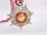 a red ribbon with a star and a star on it