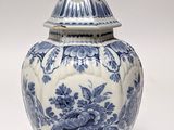 a blue and white vase with a bird on it