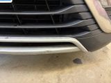 a close up of a car ' s grille with a number plate on it