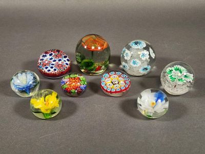 six glass marbles with different designs on them sitting on a table