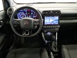 the interior of a small car with a steering wheel and dashboard