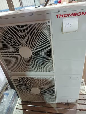 two air conditioners sitting on a pallet in a warehouse