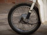 a close up of a motorcycle wheel on a concrete surface