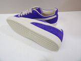 purple and white tennis shoes on a white surface