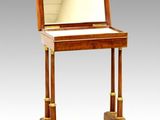 a small wooden desk with a mirror on top of it