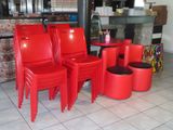four red chairs and a table in a restaurant
