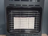 a close up of a gas heater on a wooden table