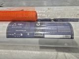 a roll of plastic on the ground next to a roll of plastic