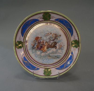 a plate with a picture of a man on a sleigh on it