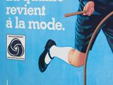 advertisement of a man riding a bicycle with a hula hoop in front of him