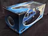a box with a toy car in it on a black background