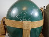 a green bottle with a brown strap around it