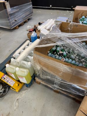 a cart full of bottles of water sitting on the floor