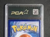the card is in a plastic case with a picture of a pokemon ball on it
