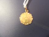 une médaille d'or avec la photo d'une femme dessus