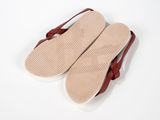 a pair of brown sandals on a white surface
