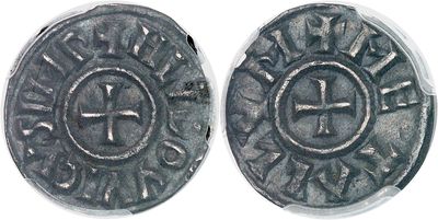 a close up of a coin with a cross on it
