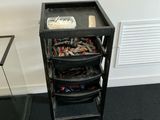 a black cart with a bunch of electronics inside of it