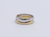 an image of two gold and silver rings on a white surface
