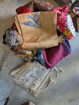 a pile of cloths sitting on the floor next to a chair
