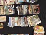 many cards laid out on a table with a black background