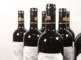 several bottles of wine are lined up in a row on a table