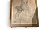 painting of a man on a horse in a box on a white surface