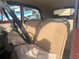 a woman sitting in the back seat of a car