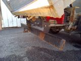 a dump truck that is parked next to a building