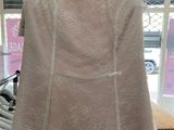 a white dress on a hanger in a store