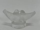 two glass birds that are sitting on top of a glass bowl