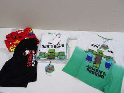 three t - shirts that are on a table