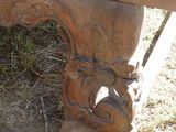 a wooden bench with carvings on it sitting in the grass
